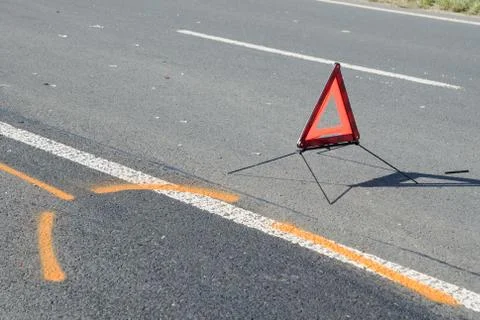 Warning triangle and drift marker on the road after the accident Stock Photos