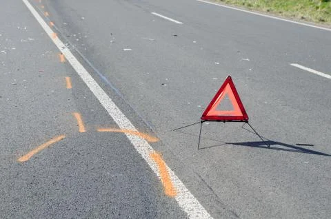 Warning triangle and drift marker on the road after the accident Stock Photos