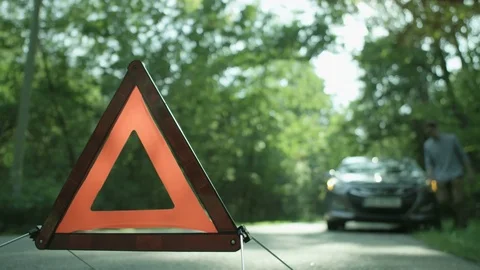 Warning Triangle. Man Opening the Hood of his Car Stock Footage