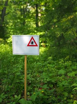 Warning, white placard with a tick pattern, the placard has a place to text. Stock Photos