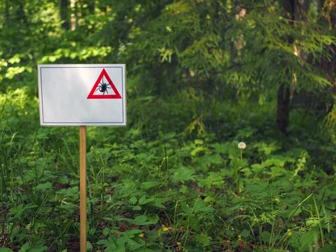 Warning, white placard with a tick pattern, the placard has a place to text. Stock Photos