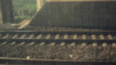 Warped view of passing train tracks from within a moving train Stock Footage 159006890