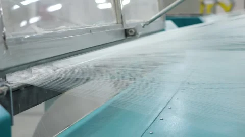 Warping machine close-up, threads are pulled in even rows, loom, fabric making Stock Footage 271729281