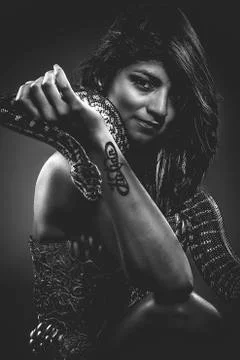Warrior, brunette woman posing with a python snake australian Stock Photos