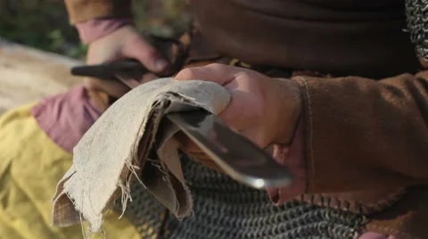 Warrior In Chain Mail Cleans Rubs Sword In Forest Stock-Footage 63078000