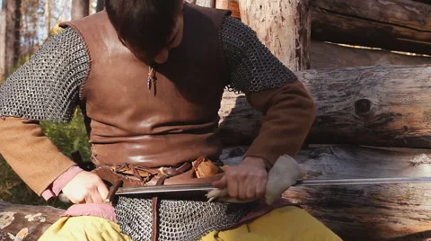 Warrior In Chain Mail Cleans Rubs Sword In Forest Stock Footage 63078028