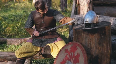 Warrior In Chain Mail Cleans Rubs Sword In Forest Stock Footage 63078067