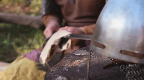 Warrior In Chain Mail Cleans Rubs Sword In Forest Stock Footage 63078076
