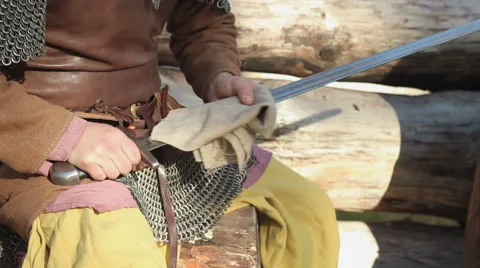 Warrior In Chain Mail Cleans Rubs Sword In Forest Stock Footage 63078130