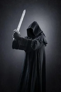 Warrior with hooded cape and medieval sword over dark misty background Stock Photos