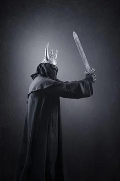 Warrior with horned helmet and sword in the dark Stock Photos