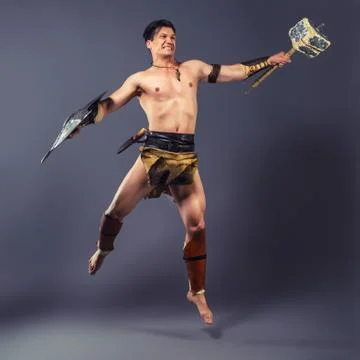 The warrior in the image of the ancient world. Strike of the hammer. Stock-Fotos
