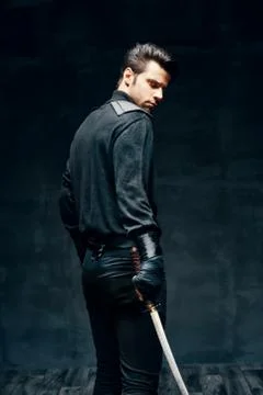 Warrior man posing with a sword Stock-Fotos