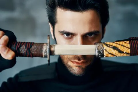 Warrior man posing with a sword Foto stock