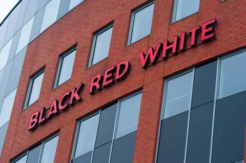 Warsaw, Poland - September 10, 2022: Building with modern Black Red White log Stock Photos