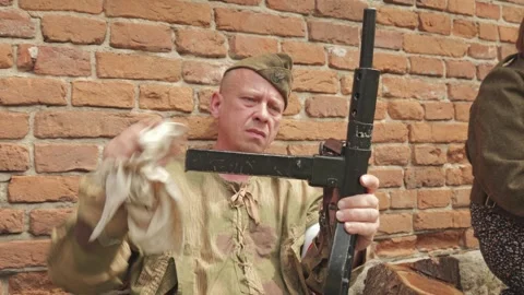 Warsaw Uprising reenactor inserting STEN gun magazine Stock Footage 339204534