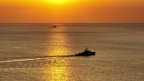 Warship passing by Bugio during Sunset Video stock 184493513