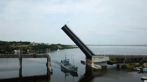 A warship sails under a raised bridge. the concept of safety Stock Footage 196398417