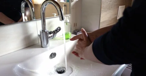 Wash hands in a bathroom Stock Footage 126276051