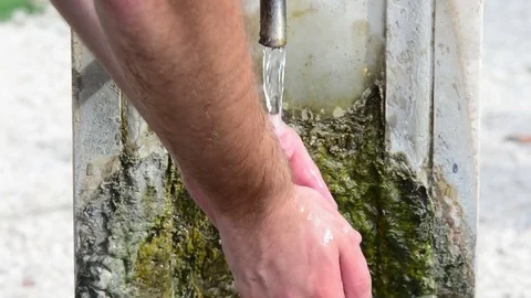 Wash the hands. Splashed water drops in a stone standpipe, in a park of Rome, Stock Footage 80427790