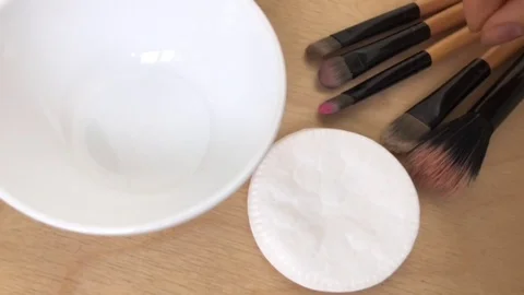 Wash make-up brushes. The cleansing liquid of brushes lies on the table close-up Stock Footage 76380143