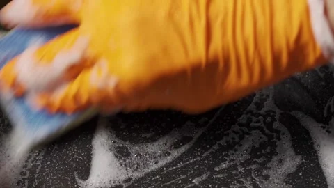 Wash the Pan with a Sponge and Detergent. A Gloved Hand with a Sponge Washes the Stock Footage 168732277