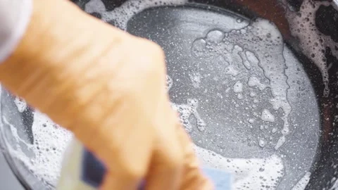 Wash the Pan with a Sponge and Detergent. A Gloved Hand with a Sponge Washes the Stock Footage 223344558