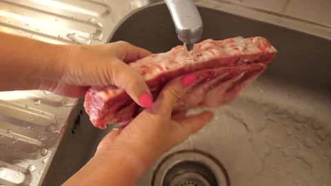 Wash the pork backbone and put it to boil. Preparation of meat dishes. Stock Footage 283441359