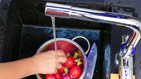 Wash the radish in the sink Stock Footage 84438855
