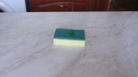 Wash the table with yellow gloves with a sponge Stock Footage 137329839