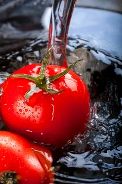 Wash tomatoes Stock Photos