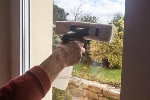 To wash the window of a door Stock Photos
