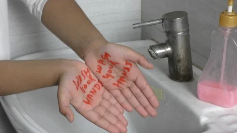 Wash your hands text message written on hands and showing how to wash them. Video stock 126270086
