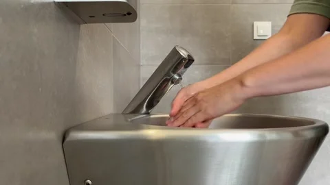 Wash your hands with a touchless tap 스톡 동영상 283727220
