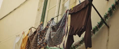 Washed clothes hanged to dry outside Stock Footage 151395632