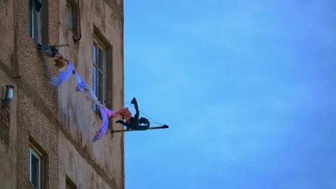 Washed clothes hanging on ropes outside the window of an apartment building Stock Footage 257592971