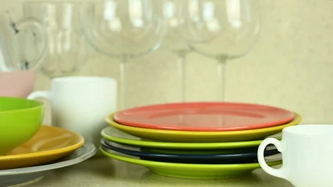 Washed colored dishes stand in kitchen with glass wine glasses Stock Footage 122560008