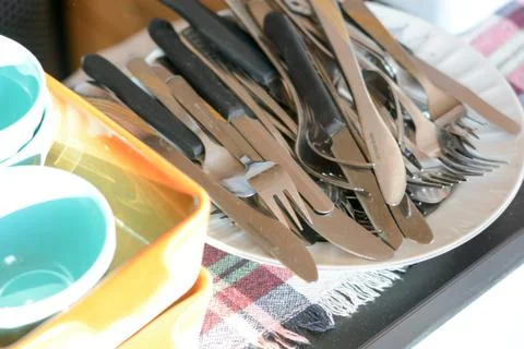 Washed knifes and forks on the ceramic plate Stock Photos