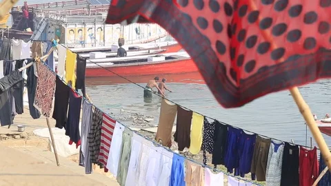 Washed laundry is dried on rope at  ghats next Ganges River. Varanasi, India Stock-Footage 84077519
