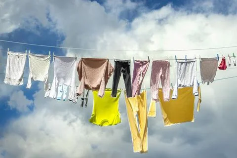 Washed Laundry Drying on Wires in Wind Stock Photos