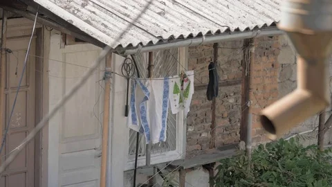 Washed laundry hangs on a rope, Georgia Video stock 83989095