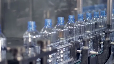 Washed up PET bottles transported by a conveyor for further processing. 4K. 動画素材 77380068