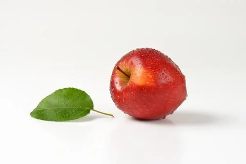Washed red apple with leaf on white background Stock Photos