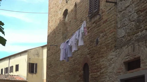 Washed things are drying on lines stretched along the wall. Stock Footage 136769722