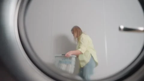 Washer Door Reflection Shows Worker Dancing With Basket 스톡 동영상 318843824