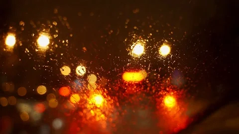 Washer fluid is sprayed onto the windshield of a car. Car brushes clean the Stock Footage 124648309