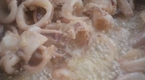 Washers squid that turn in the fryer while cooking in hot oil Video stock 46019422