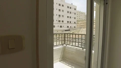 Washes the balcony door with a mop for the windows. Stock Footage 78215003
