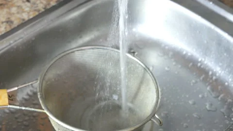 Washes a bunch of dill under running water Stock Footage 104131940