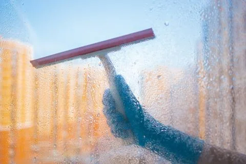 Washes the glass of a large window. Stock Photos